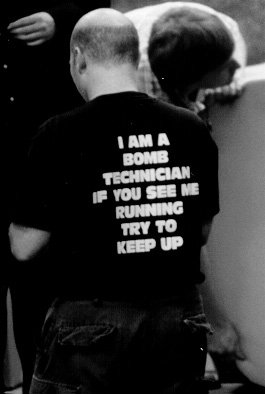 Guy in a t-shirt which reads - I am a bomb techncian if you see me running try to keep up.